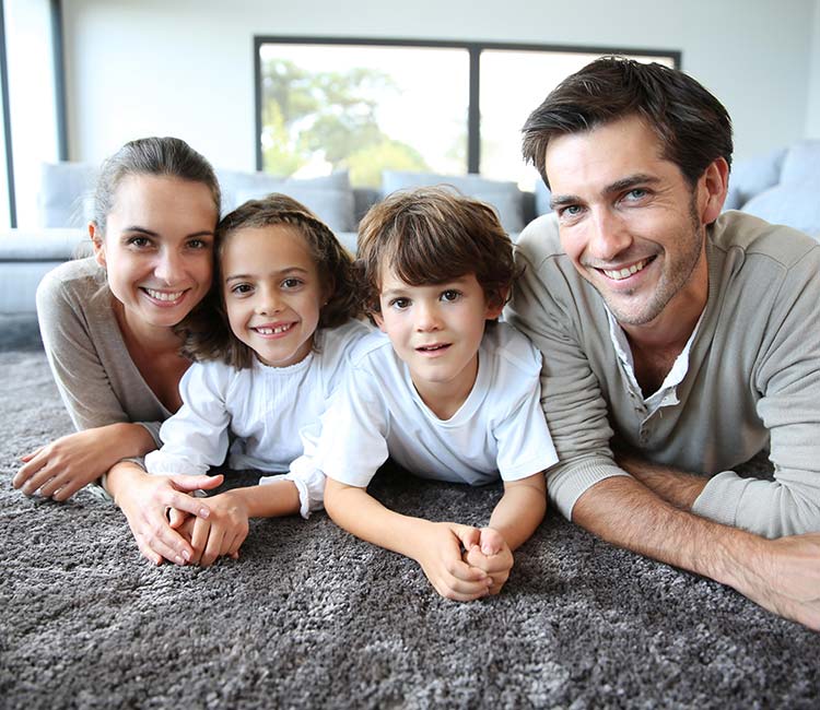 A family posing for a picture in their comfortable home in Murrells Inlet