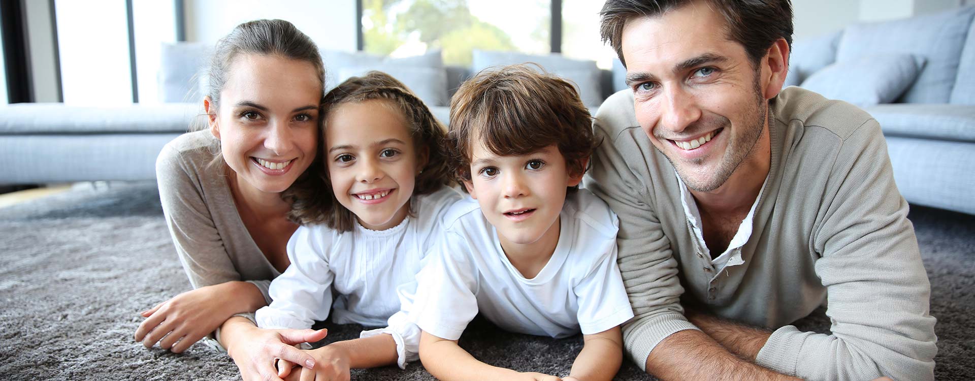 A family posing for a picture in their comfortable home in Murrells Inlet