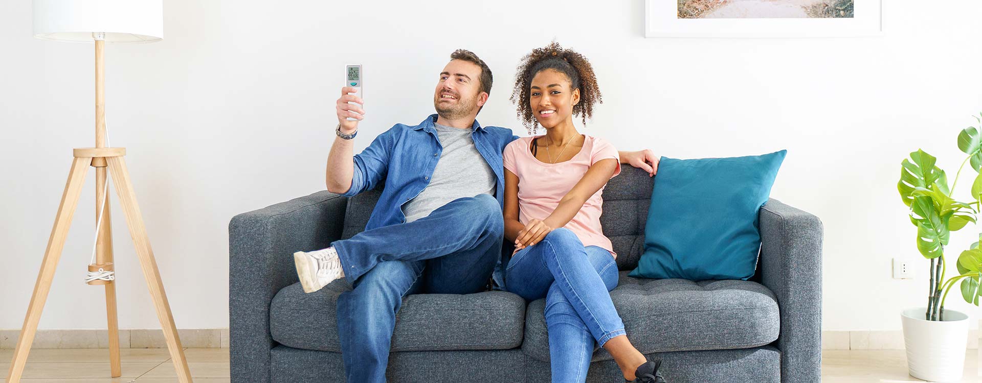 Two people sitting on a couch after a successful HVAC repair