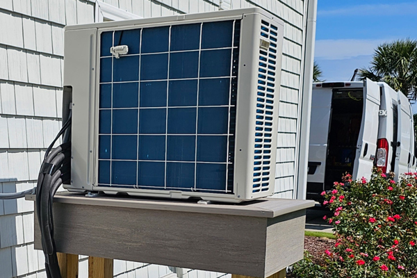 An HVAC air conditioner unit mounted on a wood platform in Surfside