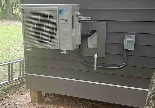 An air conditioner positioned on the side of a house for optimal cooling