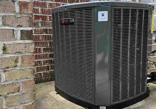 A heat pump located outside a brick building in Georgetown