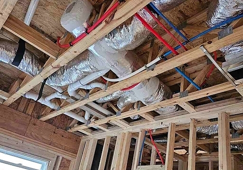 A white air conditioner unit mounted on a wall for cooling